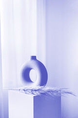 New 2022 trending PANTONE 17-3938 Very Peri color. Stylish home decor in trendy colors. Ceramic vase. Vertical photo