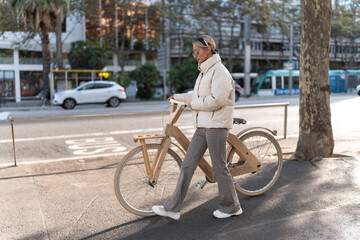 Female cyclist strolling near road