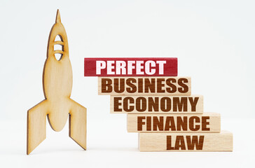 On the white surface there is a wooden rocket and planks, on the red plaque the inscription - PERFECT