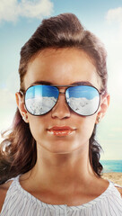 Fototapeta na wymiar Portrait of a beautiful girl in sunglasses on a sunny day.