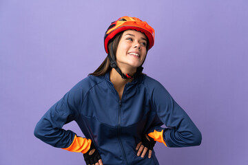 Teenager cyclist girl posing with arms at hip and smiling - obrazy, fototapety, plakaty