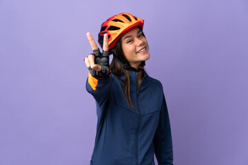 Teenager cyclist girl smiling and showing victory sign - obrazy, fototapety, plakaty