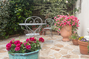 Flowered terrace with garden furniture