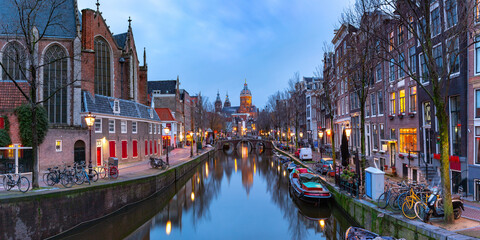 Panorama of canal in De Wallen, famous red-light district in the twilight, Amsterdam, Holland, Netherlands.