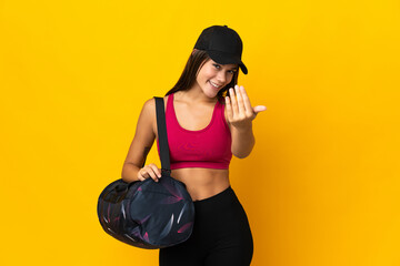 Teenager sport girl with sport bag inviting to come with hand. Happy that you came
