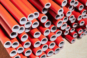 Thermal insulation PE foam for covering pipes. Red PE foam insulation tube