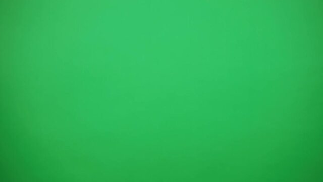 Young playful redhead curly woman in eyeglasses and panama hat walking and showing gotcha gesture to camera