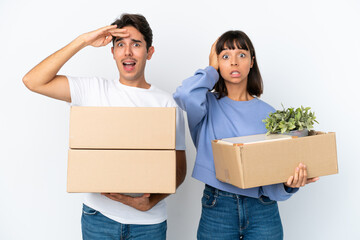 Young couple making a move while picking up a box full of things isolated on white background has just realized something and has intending the solution