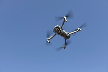 bottom close-up view of a small drone flying in the air