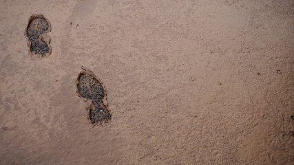 background image, footprints of boots in the swamp. space for text