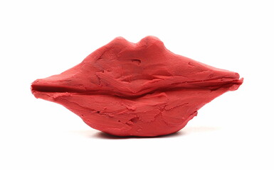 Red modelling plasticine, clay in shape lips, figurine isolated on white  