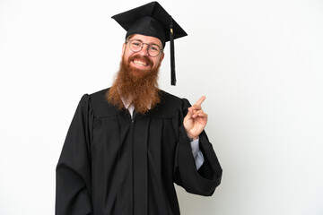 Young university graduate reddish man isolated on white background pointing finger to the side