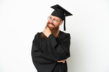 Young university graduate reddish man isolated on white background looking to the side and smiling