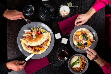a man and a woman have breakfast in a German cafe close - up view from above