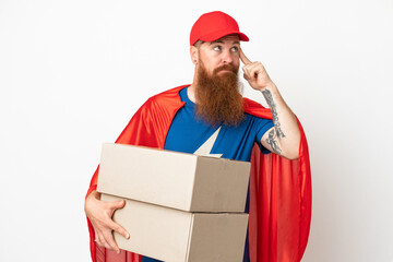 Super Hero delivery reddish man isolated on white background having doubts and thinking