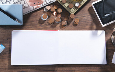 Empty notepad, coins, pen and business objects.