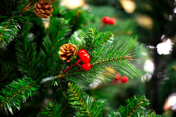 Christmas tree with decorations and pine cones, blurred background with bokeh. Celebrating New Year and Christmas