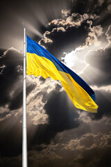 National flag of Ukraine waving in the wind against the backdrop of the sunset sky