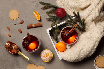 Mulled wine or glegg with tangerines and spices, knitted plaid, fir branches and ginger cookies. Top view