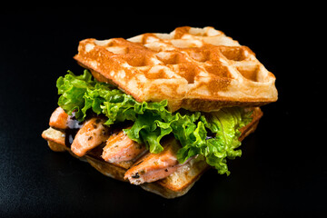 Belgian waffles sandwich with smoked salmon and vegetables