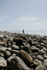 man on the rocks on the beach