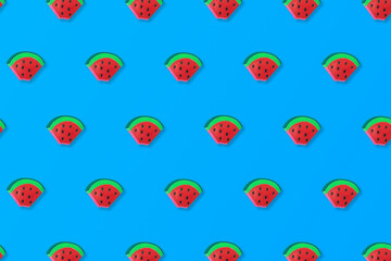 pattern made of slices of watermelon on a blue background. Cool, summer idea.
