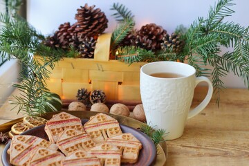 Christmas eve. Cookies in shape of houses and cup of tea