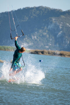 Kitesurfer athlete doing double backroll on air