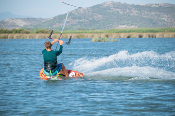 Fototapeta premium Kitesurfer athlete surfing on sea surface