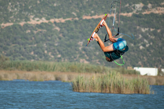 Kitesurfer athlete doing double backroll on air