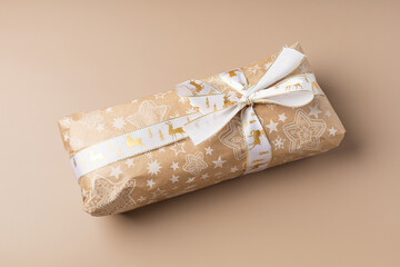 Wrapped Christmas gift with bow on a light background minimalism