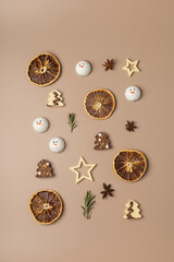 Christmas decor of dried oranges, stars, chocolate, rosemary on a beige background