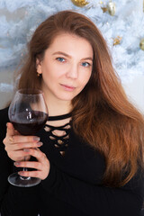 Portrait of a young beautiful woman with a glass of wine.