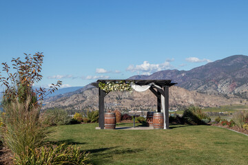 A pergola decorated with flowers for a wedding at vineyard  in the Okanagan Valley, British Columbia, Canada - obrazy, fototapety, plakaty
