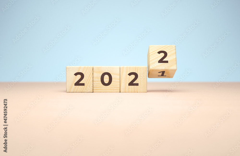 Poster 2022 new year wooden cubes flipping in 3d rendering on a minimal background. holiday illustration fo