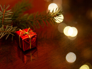 Prezent na tle gałęzi jodły, święta bożego narodzenia, dekoracja, boże narodzenie, światełka   