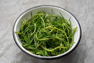 Bunch of fresh rosemary on a gray background