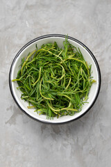 Bunch of fresh rosemary on a gray background