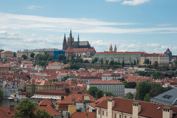 Fototapeta premium Cityscape of Prague and many of it's famous buildings such as the Church of Our Lady before Týn and Prague Castle from a viewpoint at the Powder Tower - Prague, Czech Republic