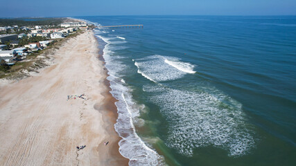 Aerial drone view of where the east coast of Florida meets the Atlantic Ocean as the waves crash on the sandy shores of St Augustine 