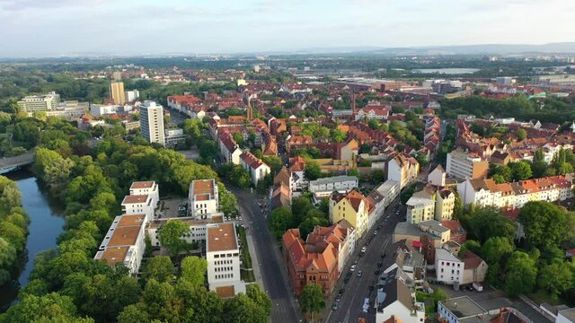 Aerial tilt up shot showing cityscape of german city named Hanover during sunny day in Germany