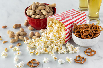 Containers of salty snacks overflowing and spilled out in front.
