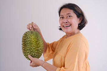 woman holding fresh durian fruit - obrazy, fototapety, plakaty