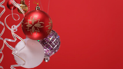 Merry Christmas and Happy new year concept. Red New year ball on a red background. Beautiful festive screensaver. Merry christmas congratulation. Christmas New Year minimal concept with copy space.