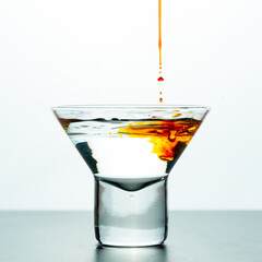 Glass with orange water drop