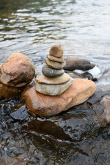 Fototapeta na wymiar Stack of zen stones on river
