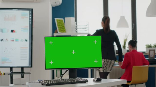 Close up of computer with blank green screen in business office. Chroma key with isolated background and mock-up template on monitor display. Modern chroma-key application with copy space