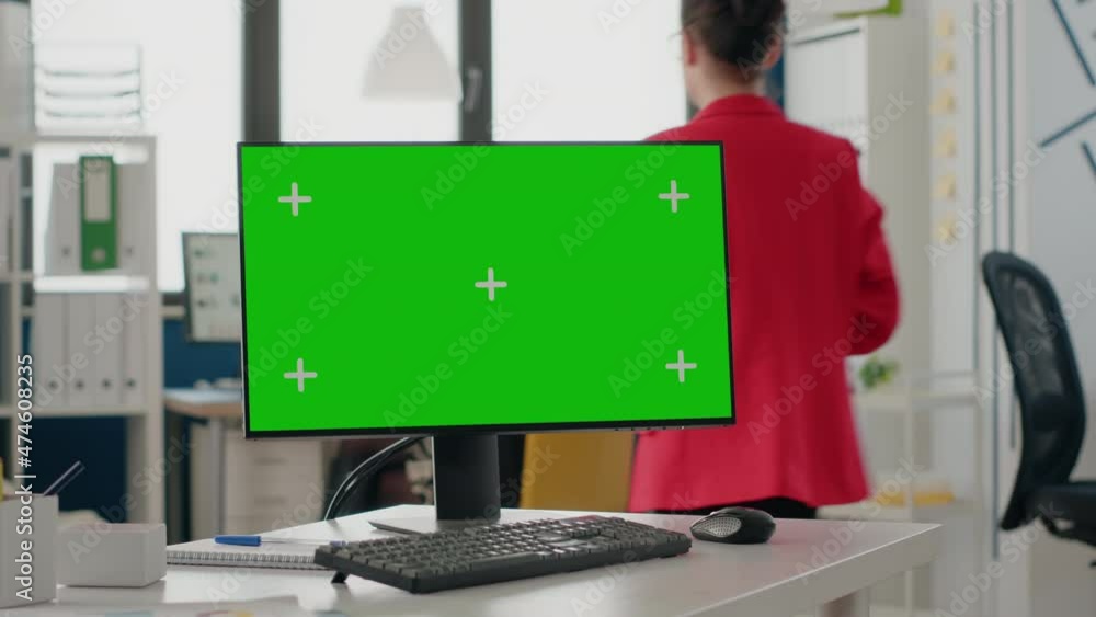 Poster close up of green screen on computer monitor at empty desk. device with isolated mock up template an