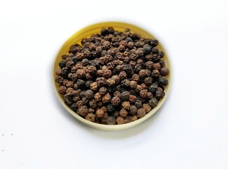 Pile of black pepper corns isolated.
