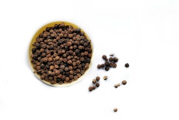 Pile of black pepper corns isolated.